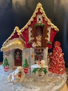 Red-roofed gingerbread house with polar bear figurine